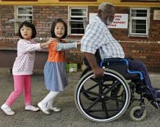 girls pushing wheelchair